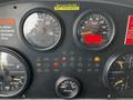 Close-up of a 2009 Spartan Gladiator dashboard featuring gauges for RPM speed fuel and air application along with warning lights and a display for hours operated