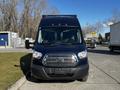 A 2017 Ford Transit van facing forward with a dark blue exterior and a silver grille featuring the Ford logo