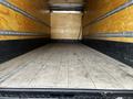 An empty 2019 Hino 338 24 foot cube truck interior showing wooden flooring and walls with metal track rails mounted along the sides