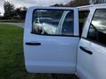 A white 2017 GMC Sierra 1500 with an open passenger door showcasing its interior and seating area