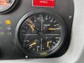 The dashboard gauge panel of a 2009 Spartan Gladiator showing four dials for oil pressure coolant level and temperature measurements