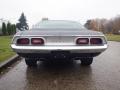 A 1974 Dodge Challenger viewed from the rear showing the distinctive taillights and chrome accents