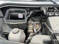 The engine compartment of a 2025 Mercedes-Benz Sprinter featuring the engine assembly and air filter housing with a warning label inside the compartment