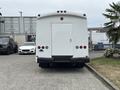 A white 2020 Chevrolet Express van parked with its rear facing the viewer showcasing a plain back and a single rear door