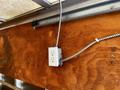 2007 GMC W3500 with a utility box attached to a wooden surface featuring electrical outlets and conduit running along the wall