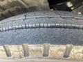 Close-up of a worn tire on a 2022 Freightliner Cascadia showing tread patterns and grooves on the rubber surface