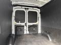Interior view of a 2022 Ford Transit van showing the cargo area with black paneling and double rear doors