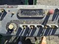 Control panel of a 2015 JLG 450AJ featuring various buttons switches and a joystick in a weathered condition