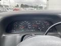 Dashboard of a 2003 Ford F-450 SD displaying speedometer RPM gauge fuel gauge and various indicator lights