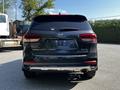A 2017 Kia Sorento viewed from the rear showcasing its taillights and the Kia logo on the back door
