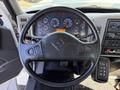Steering wheel of a 2008 International 7500 with various dashboard gauges and controls visible on the dashboard