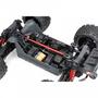 A close-up view of the Arrma 1/10 OUTCAST 4S 4X4 RTR Brushless Stunt Truck showcasing its internal components including the battery compartment and drive system