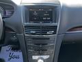Interior of a 2013 Lincoln MKT featuring a touchscreen display and control panel with various buttons and knobs for navigation and audio settings