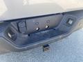 The image shows the rear bumper of a 2021 RAM 1500 with visible mounting points and hooks for towing equipment