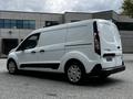 A white 2019 Ford Transit Connect van is shown from the rear angle with a sliding door and simple design features