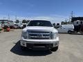 A front view of a 2014 Ford F-150 in white with a chrome grille and headlights visible