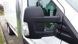 Close-up of the side mirror and door of a 2018 Ford Transit van