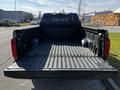 A 2023 Toyota Tundra pickup truck with an open bed showing a black lining and no cargo inside