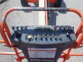 A control panel of a 2008 JLG Boom Lift featuring various buttons and levers for operation