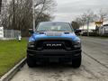 A blue 2021 RAM 1500 Classic with a black hood and bold front grille features prominently in the foreground