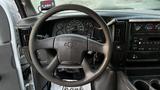 Steering wheel and dashboard of a 2005 Chevrolet Express showing speedometer and radio controls