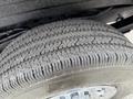 Close-up of a worn tire from a 2021 Chevrolet Express showing tread patterns and sidewall details