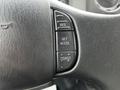 Close-up of the steering wheel controls of a 2013 Ford F-650 featuring buttons for reset acceleration set and coast