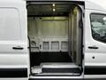 A 2017 Ford Transit van with an open side door revealing the spacious interior and a step for easy access