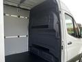 Interior view of a 2022 Mercedes-Benz Sprinter showcasing its spacious cargo area with a smooth surface and no visible shelves or obstructions