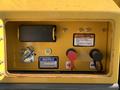 Close-up of control panel on a 2022 TerraMac Tracked Dump featuring buttons for power and a warning notice