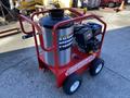 A red Magnum 4000 hot water pressure washer with a stainless steel tank and black engine mounted on a wheeled frame