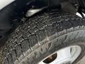 A close-up of a tire from a 2017 Chevrolet Express showing the tread pattern and some dirt on the surface