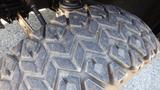 Close-up of a rugged tire from a 2016 Polaris Ranger 570 Crew showcasing a deep tread pattern suitable for off-road traction