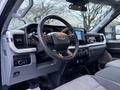 Interior view of a 2023 Ford F-250 showcasing the steering wheel dashboard and control panel with modern technology features