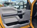 Interior door panel of a 2017 Ford F-250 SD showing a gray design with a black handle and control buttons for windows and locks