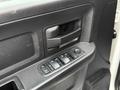 Close-up of a 2013 RAM 3500 door panel featuring a window control switch and door handle in a textured black finish