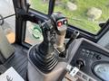 Control joystick of a 2005 Case 570 featuring buttons and grips for operating machinery