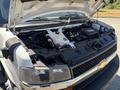 A 2020 Chevrolet Express with its hood open revealing the engine compartment including the engine and various engine components