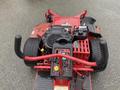 A 2017 Ferris Rotary mower featuring large rear tires a control panel with various switches and a red framework supporting the engine and components