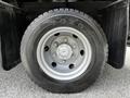 Close-up of a silver wheel with a black Toyo tire mounted on a 2015 Mitsubishi Fuso FE vehicle