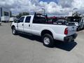 A white 2016 Ford F-350 Super Duty with a spacious bed and dual rear wheels parked on a lot