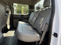 Interior view of the backseat of a 2018 Ford F-550 with gray leather seats and a spacious layout