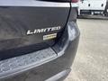 A 2015 Dodge Durango limited badge with a flex fuel sticker on the rear of the vehicle