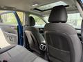 The image shows the interior of a 2021 Kia Forte featuring two front seats with black upholstery and a sunroof above