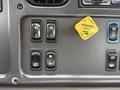 A close-up view of the control panel in a 2016 Freightliner 108SD featuring various buttons for parking brake mirror heat and lights