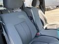 Interior view of a 2014 Ford F-150 showing front bucket seats with gray cloth upholstery and seatbelt attachment on the side