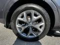 Close-up of a silver alloy wheel on a 2017 Kia Sorento showing five spokes and a tire with a thick tread pattern