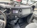 Interior dashboard of a 2015 Ford F-550 featuring a navigation screen various controls and the Super Duty emblem
