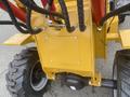 A 2024 AGT KRW 23 Mini loader showing its yellow chassis and black hydraulic hoses leading to the engine compartment and wheels