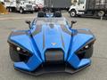 A blue 2020 Polaris SlingShot with a sleek design featuring two seats and prominent headlights